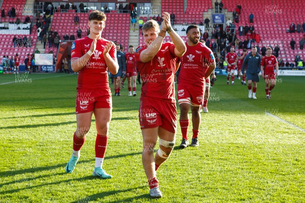230324 - Scarlets v Benetton - United Rugby Championship - Eddie James, Teddy Leatherbarrow and Carwyn Tuipulotu of Scarlets show their appreciation to the crowd at the end of the match