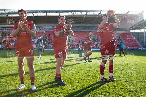 230324 - Scarlets v Benetton - United Rugby Championship - Johnny Williams, Sam Wainwright and Morgan Jones of Scarlets show their appreciation to the crowd at the end of the match