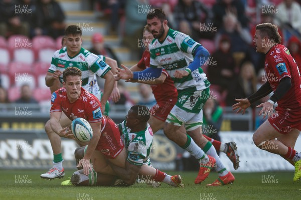 230324 - Scarlets v Benetton - United Rugby Championship - Kieran Hardy of Scarlets offloads the ball