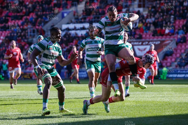 230324 - Scarlets v Benetton - United Rugby Championship - Tom Rogers of Scarlets tackles Jacob Umaga of Benetton in the air