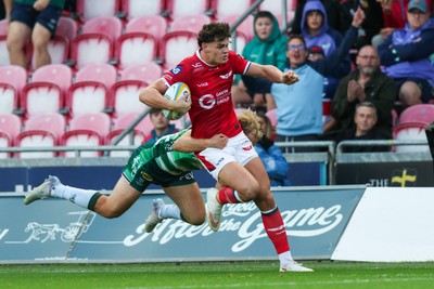 101026 - Scarlets v Benetton Rugby - United Rugby Championship - Eddie James of Scarlets is tackled by Louis Lynagh of Benetton