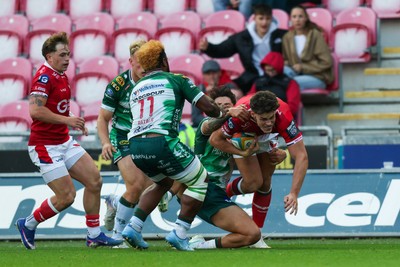 101026 - Scarlets v Benetton Rugby - United Rugby Championship - Eddie James of Scarlets is tackled by Louis Lynagh of Benetton