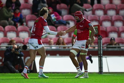 101026 - Scarlets v Benetton Rugby - United Rugby Championship - Ellis Mee of Scarlets is congratulated by Josh Macleod of Scarlets after scoring his second try