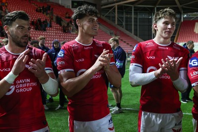 101026 - Scarlets v Benetton Rugby - United Rugby Championship - Johnny Williams, Eddie James and Ellis Mee of Scarlets at the end of the match