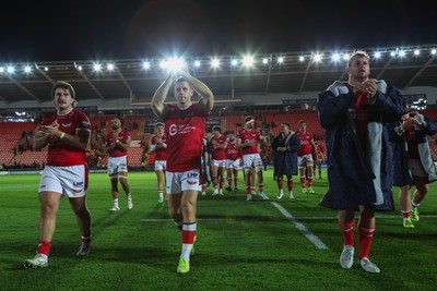 101026 - Scarlets v Benetton Rugby - United Rugby Championship - John McKee, Gareth Davies and Ryan Elias of Scarlets applaud fans at the end of the match