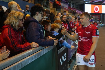 101026 - Scarlets v Benetton Rugby - United Rugby Championship - Sam Costelow of Scarlets with fans at the end of the match
