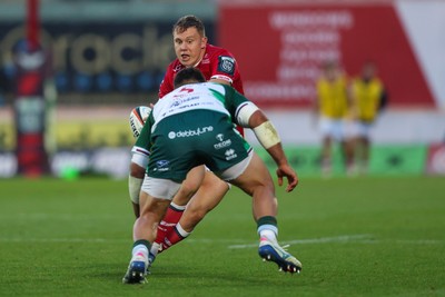 101026 - Scarlets v Benetton Rugby - United Rugby Championship - Sam Costelow of Scarlets takes on Mattia Midena of Benetton