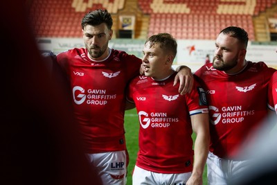 101026 - Scarlets v Benetton Rugby - United Rugby Championship - Johnny Williams, Sam Costelow and Harri O'Connor of Scarlets at the end of the match