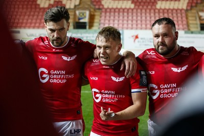 101026 - Scarlets v Benetton Rugby - United Rugby Championship - Johnny Williams, Sam Costelow and Harri O'Connor of Scarlets at the end of the match
