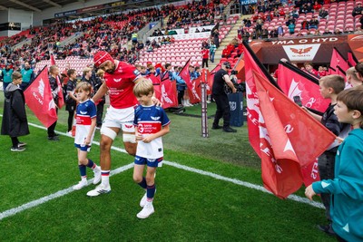 101026 - Scarlets v Benetton Rugby - United Rugby Championship - Josh Macleod of Scarlets runs onto the pitch with the mascots