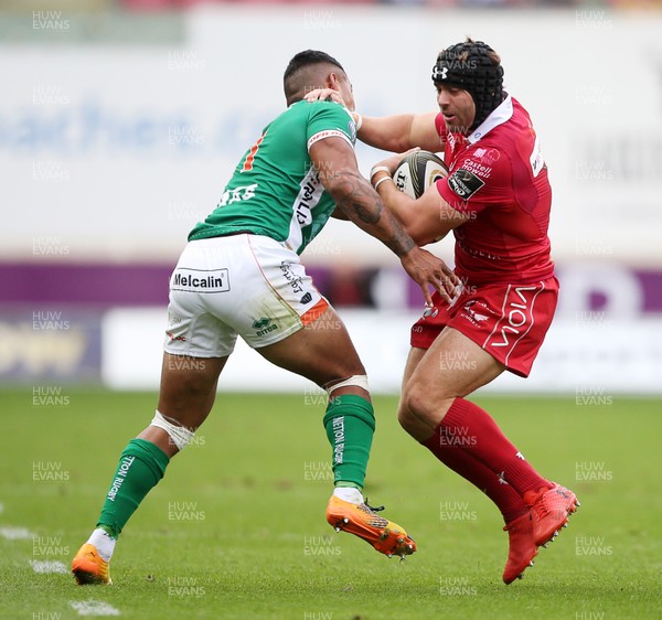 150918 - Scarlets v Benetton Rugby - Guinness PRO14 - Leigh Halfpenny of Scarlets is tackled by Monty Ioane of Benetton