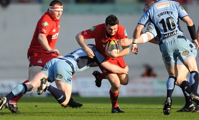 17.04.10 - Scarlets v Cardiff Blues - Magners League - Stephen Jones of Scarlets is tackled by Martyn Williams of Cardiff Blues. 