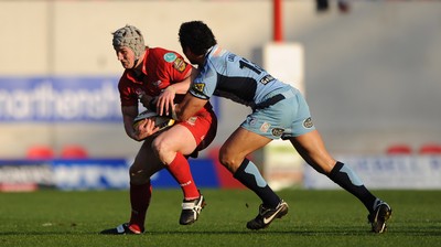 17.04.10 - Scarlets v Cardiff Blues - Magners League - Jonathan Davies of Scarlets is tackled by Casey Laulala of Cardiff Blues. 