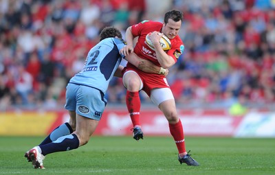 17.04.10 - Scarlets v Cardiff Blues - Magners League - Daniel Evans of Scarlets is tackled by Jamie Roberts of Cardiff Blues. 