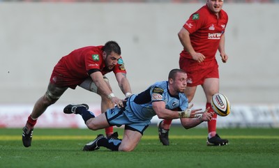 17.04.10 - Scarlets v Cardiff Blues - Magners League - Richie Rees of Cardiff Blues is tackled by Josh Turnbull of Scarlets. 