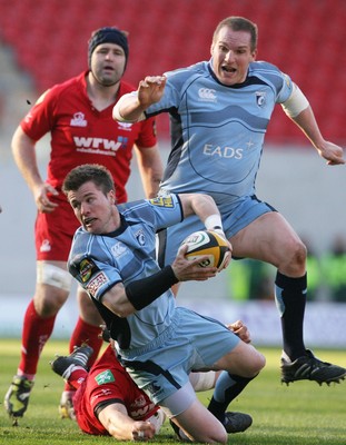 17.04.10 Scarlets v Blues... Blues Ceri Sweeney is tackled by Scarlets Dominic Day. 