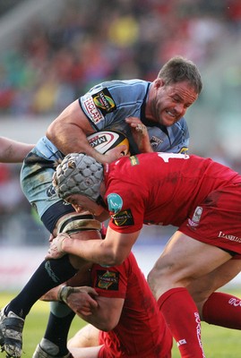 17.04.10 Scarlets v Blues... Blues Xavier Rush is tackled by Scarlets Jonathan Davies and Tavis Knoyle. 