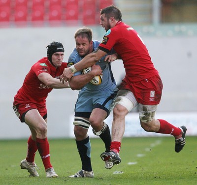 17.04.10 Scarlets v Blues... Blues Xavier Rush is tackled by Scarlets Josh Turnbull and  Andy Fenby. 