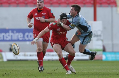 17.04.10 Scarlets v Blues... Scarlets Andy Fenby feels the force of a tackle by Blues' Ceri Sweeney . 