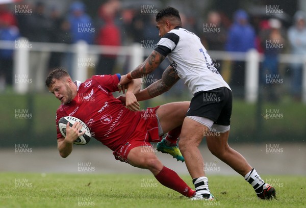 180818 - Scarlets v Bristol Bears - Pre Season Friendly - Steff Hughes of Scarlets is tackled by Ian Madigan and Tusi Pisi of Bristol Bears