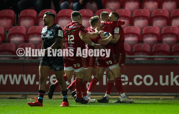 220122 - Scarlets v Bristol Bears, Heineken Champions Cup - Johnny McNicholl of Scarlets celebrates with team mates after he dives in to score try