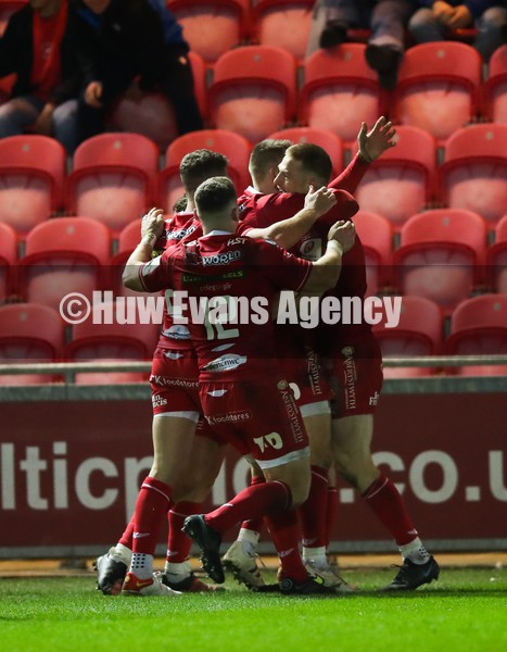 220122 - Scarlets v Bristol Bears, Heineken Champions Cup - Johnny McNicholl of Scarlets celebrates with team mates after he dives in to score try