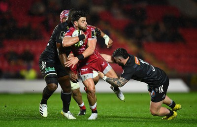 310323 - Scarlets v Brive - European Rugby Challenge Cup - Johnny Williams of Scarlets is tackled by Mesu Kunavula and Sam Arnold of Brive