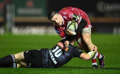 310323 - Scarlets v Brive - European Rugby Challenge Cup - Steff Evans of Scarlets is tackled by Stuart Olding of Brive