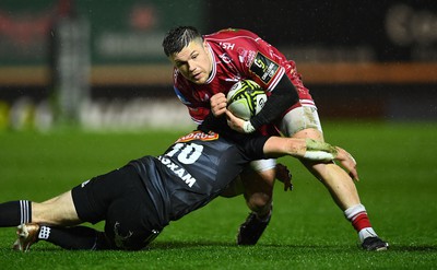 310323 - Scarlets v Brive - European Rugby Challenge Cup - Steff Evans of Scarlets is tackled by Stuart Olding of Brive