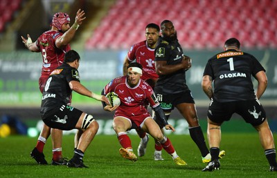 310323 - Scarlets v Brive - European Rugby Challenge Cup - Tom Rogers of Scarlets takes on Retief Marais of Brive