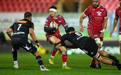 310323 - Scarlets v Brive - European Rugby Challenge Cup - Tom Rogers of Scarlets takes on Retief Marais of Brive