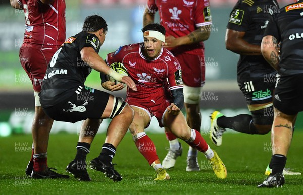 310323 - Scarlets v Brive - European Rugby Challenge Cup - Tom Rogers of Scarlets takes on Retief Marais of Brive
