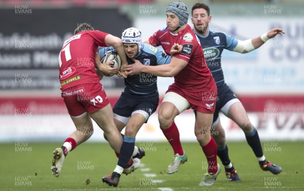 010117 - Scarlets v Cardiff Blues - Guinness PRO12 - Matthew Morgan of Cardiff Blues is tackled by Steff Evans and Jonathan Davies of Scarlets by Ben Evans/Huw Evans Agency