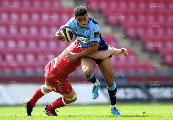 150521 - Scarlets v Cardiff Blues - Guinness PRO14 Rainbow Cup - Ben Thomas of Cardiff Blues is tackled by Jac Morgan of Scarlets