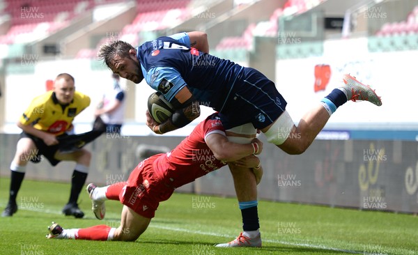 150521 - Scarlets v Cardiff Blues - Guinness PRO14 Rainbow Cup - Josh Turnbull of Cardiff Blues is tackled by Tom Rogers of Scarlets