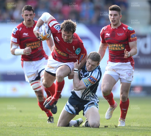 200413 - Scarlets v Cardiff Blues - RaboDirect PRO12 -Andy Fenby of Scarlets is tackled by Owen Williams of Cardiff Blues 