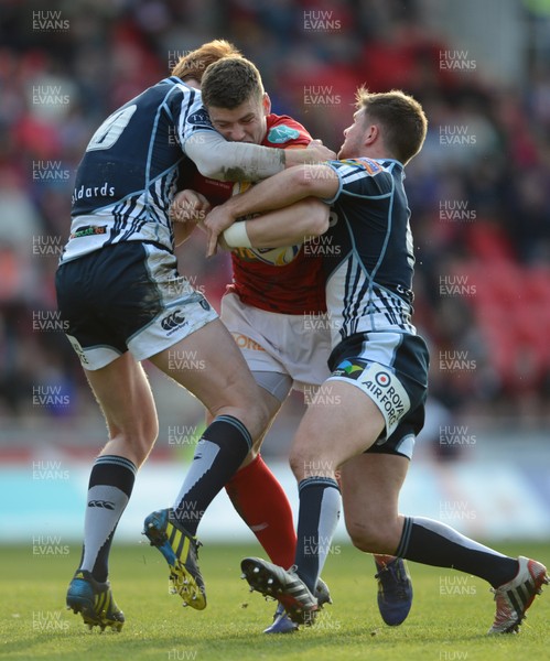 200413 - Scarlets v Cardiff Blues - RaboDirect PRO12 -Scott Williams of Scarlets is tackled by Rhys Patchell and Lewis Jones of Cardiff Blues 