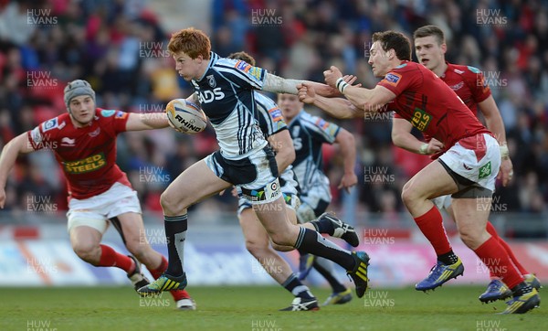 200413 - Scarlets v Cardiff Blues - RaboDirect PRO12 -Rhys Patchell of Cardiff Blues is tackled by George North of Scarlets 