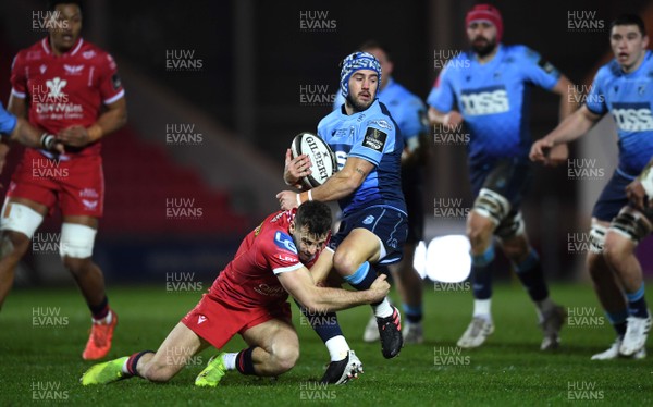 220121 - Scarlets v Cardiff Blues - Guinness PRO14 - Matthew Morgan of Cardiff Blues is tackled by Gareth Davies of Scarlets