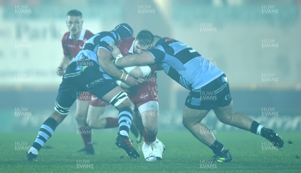 291218 - Scarlets v Cardiff Blues - Guinness PRO14 - Rob Evans of Scarlets is tackled by George Earle and Dillon Lewis of Cardiff Blues