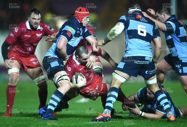 291218 - Scarlets v Cardiff Blues - Guinness PRO14 - Ken Owens of Scarlets is tackled by Seb Davies and Dillon Lewis of Cardiff Blues
