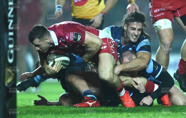 291218 - Scarlets v Cardiff Blues - Guinness PRO14 - Gareth Davies of Scarlets is tackled by Josh Navidi of Cardiff Blues