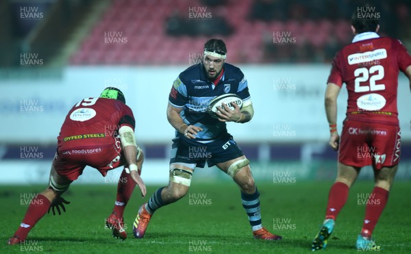 291218 - Scarlets v Cardiff Blues - Guinness PRO14 - Josh Turnbull of Cardiff Blues is tackled by Tom Price of Scarlets
