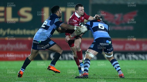 291218 - Scarlets v Cardiff Blues - Guinness PRO14 - Tom Prydie of Scarlets is tackled by Willis Halaholo and Josh Turnbull of Cardiff Blues