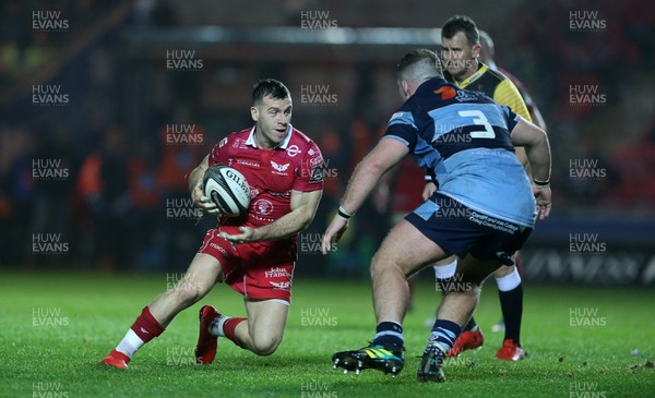 291218 - Scarlets v Cardiff Blues - Guinness PRO14 - Gareth Davies of Scarlets is challenged by Dillon Lewis of Cardiff Blues