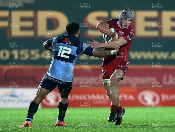 291218 - Scarlets v Cardiff Blues - Guinness PRO14 - Jonathan Davies of Scarlets is tackled by Willis Halaholo of Cardiff Blues