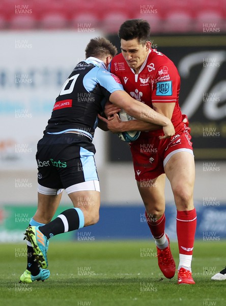 020422 - Scarlets v Cardiff Rugby - United Rugby Championship - Tomas Lezana of Scarlets is tackled by Jarrod Evans of Cardiff