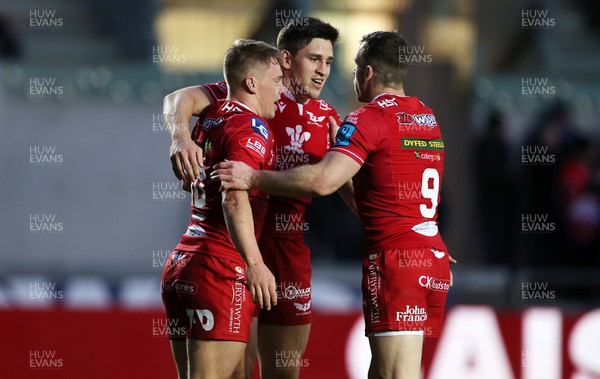 020422 - Scarlets v Cardiff Rugby - United Rugby Championship - Sam Costelow of Scarlets celebrates scoring a try with Tomas Lezana and Gareth Davies