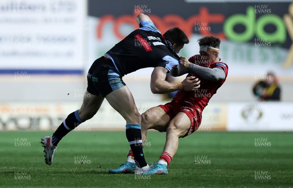 020422 - Scarlets v Cardiff Rugby - United Rugby Championship - Josh Adams of Cardiff is tackled by Tom Rogers of Scarlets 