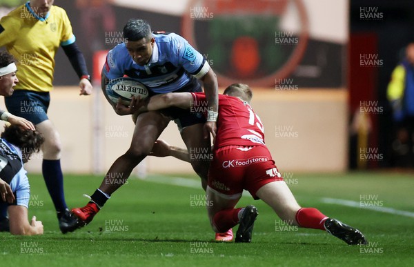 020422 - Scarlets v Cardiff Rugby - United Rugby Championship - Rey Lee-Lo of Cardiff is tackled by Johnny McNicholl of Scarlets